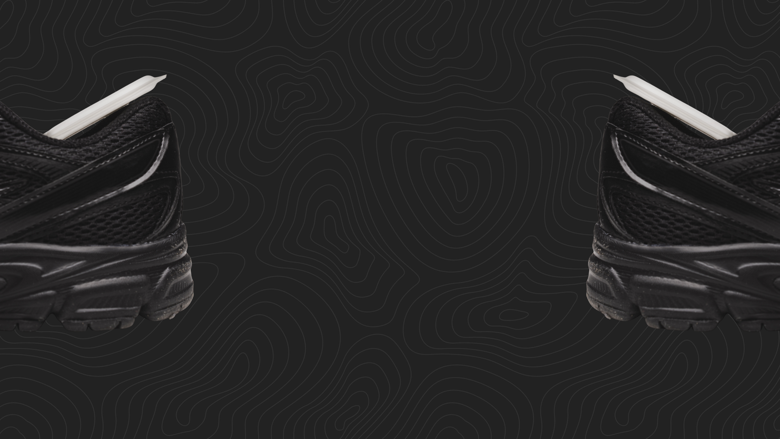 Black athletic shoes with white Numadx inserts on a black background